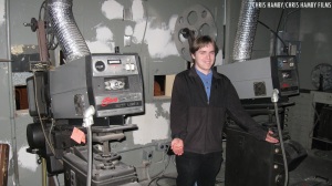 Chris Hamby, standing next to two vintage Simplex X-L projectors at the Weinberg Center for the Arts (the former Tivoli Cinema) in Frederick, Maryland.